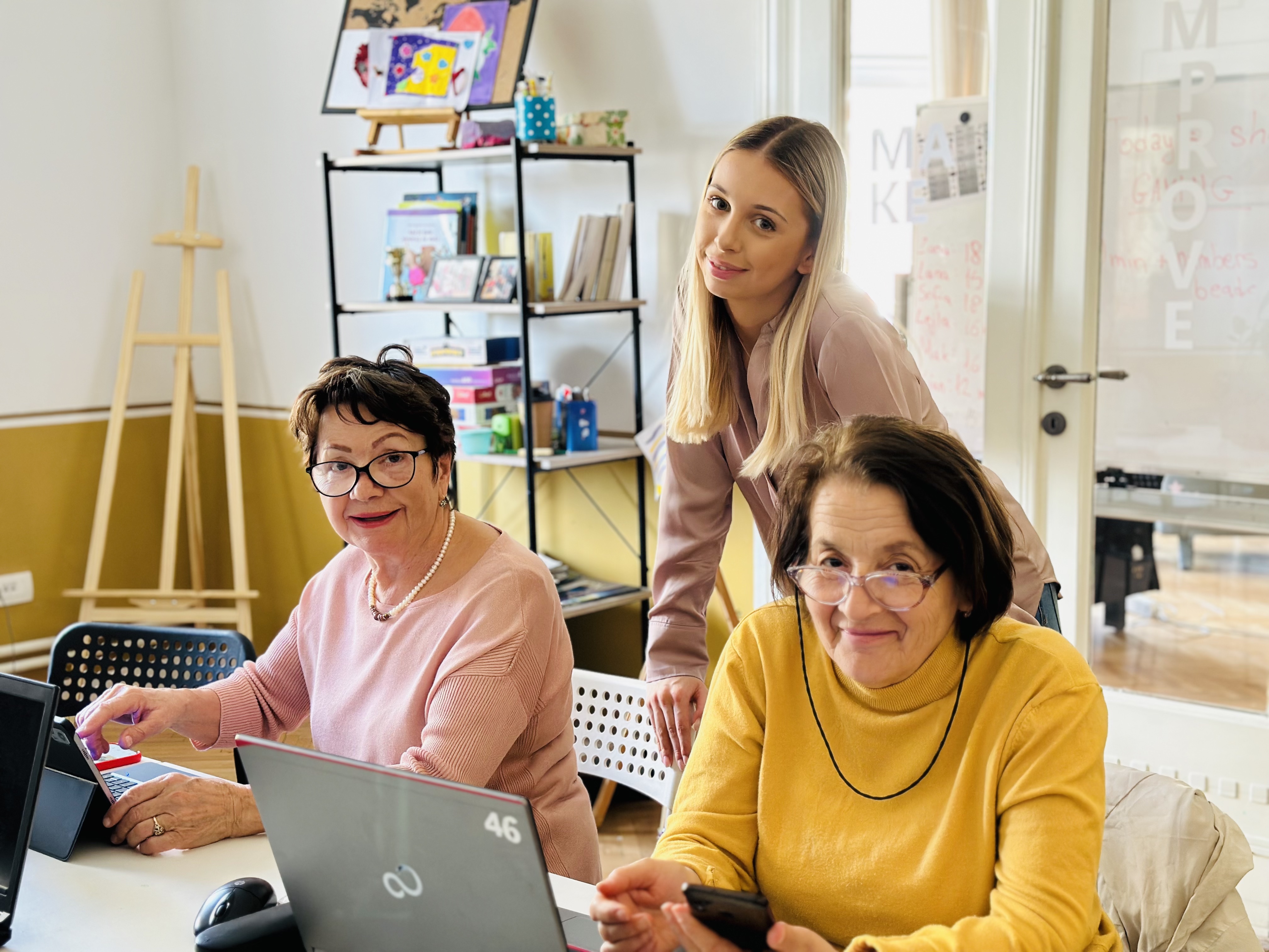 image of 2 ladies using a computer while an adolescent tutors them